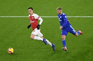 Arsenal V Cardiff City 2018-19 Prints: Intense Clash: Ozil vs. Bennett in Arsenal's Battle Against Cardiff
