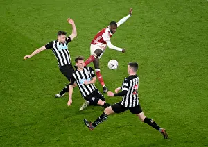 Intense Defensive Pressure: Arsenal's Nicolas Pepe Faces Off Against Newcastle's Triple Threat in FA Cup Clash