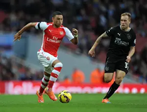 Arsenal V Burnley 2014/15 Prints: Intense Face-Off: Alex Oxlade-Chamberlain vs Scott Arfield at Emirates Stadium