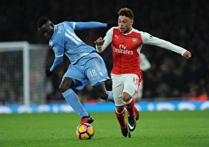 Arsenal V Stoke City 2016-17 Prints: Intense Face-Off: Oxlade-Chamberlain vs. Diouf in Arsenal vs. Stoke Premier League Clash