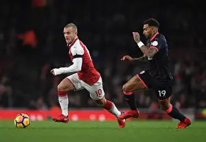 Arsenal V Huddersfield Town 2017-18 Prints: Intense Face-Off: Wilshere vs. Kachunga in Arsenal's Premier League Battle