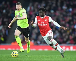 Intense Rivalry: Bukayo Saka vs. John Lundstram - Arsenal's Battle Against Sheffield United