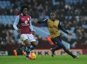 Aston Villa V Arsenal 2015-16 Prints: Intense Rivalry: Campbell vs Sanchez Showdown in Aston Villa vs Arsenal Premier League Clash