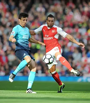 Intense Rivalry: Cazorla vs. Cork Clash at Arsenal vs Swansea City