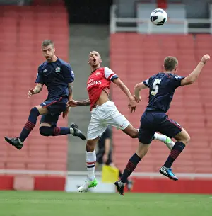 Arsenal U21 V Blackburn R U21 2012-13 Prints: Intense Rivalry: Craig Eastmond's Leap Over Molina and O'Connell during Arsenal U21s vs Blackburn Rovers