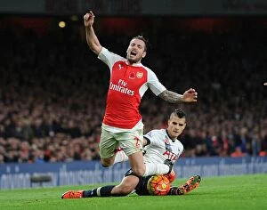 Arsenal v Tottenham Hotspur 2015-16 Collection: Intense Rivalry: Debuchy Fouls Lamela in Arsenal vs. Tottenham (2015-16)