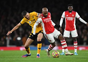 Intense Rivalry: Lacazette vs. Coady - Arsenal vs. Wolverhampton Wanderers, Premier League Battle