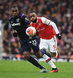 Arsenal V West Ham United 2019-20 Prints: Intense Rivalry: Lacazette vs. Diop Clash in Arsenal vs. West Ham Premier League Battle