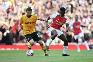 Arsenal v Wolverhampton Wanderers 2022-23 Collection: Intense Rivalry: Neves vs. Nketiah - Arsenal vs. Wolverhampton Wanderers (2022-23)