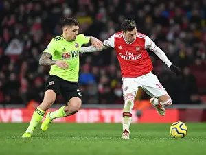 Arsenal V Sheffield United 2019-20 Prints: Intense Rivalry: Ozil vs. Baldock - Arsenal's Battle Against Sheffield United