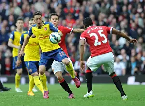 Manchester United V Arsenal 2014-15 Prints: Intense Rivalry: Ozil vs. Herrera & Valencia - Battle at Old Trafford (Manchester United vs)
