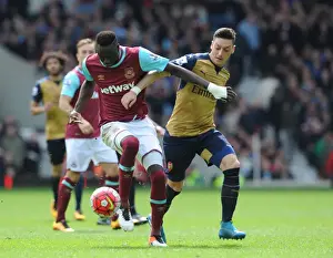 West Ham United V Arsenal 2015-16 Prints: Intense Rivalry: Ozil vs. Kouyate Clash at the Boleyn Ground (2015-16)