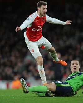 Arsenal v Southampton 2015-16 Collection: Intense Rivalry: Ramsey vs. Romeu in Arsenal's Battle with Southampton