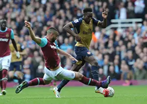 West Ham United V Arsenal 2015-16 Prints: Intense Rivalry: Welbeck vs. Reid Clash in Arsenal's Battle at The Boleyn Ground