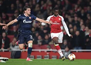 Arsenal v Red Star Belgrade 2017-18 Collection: Intense Showdown: Eddie Nketiah vs. Filip Stocjkovic in Arsenal's Europa League Battle