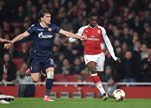 Arsenal V Red Star Belgrade 2017-18 Prints: Intense Showdown: Eddie Nketiah vs. Filip Stocjkovic in Arsenal's Europa League Battle