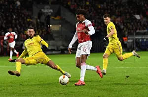 BATE Borisov V Arsenal 2018-19 Prints: Iwobi vs. Filipenko: A Tense Shooting Showdown in Europa League Clash
