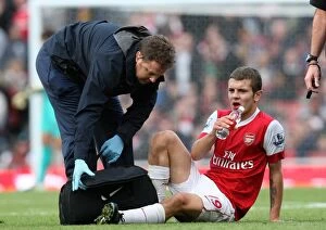 Arsenal v Birmingham City 2010-11 Collection: Jack Wilshere (Arsenal) gets treatment for a bloody lip from Physio Colin Lewin