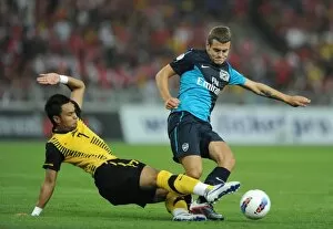 Malaysia XI v Arsenal Collection: Jack Wilshere (Arsenal) Mohd Zafuan (Malaysia). Malaysia XI 0: 4 Arsenal