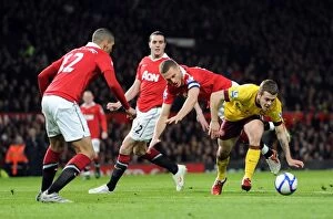 Images Dated 12th March 2011: Jack Wilshere (Arsenal) Nemanja Vidic and Chris Smalling (Man Utd). Manchester United 2