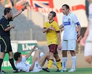 Jack Wilshere (Arsenal) is shown the yellow card by referee Alexander Harkamp