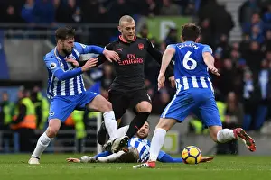 Brighton And Hove Albion V Arsenal 2017-18 Prints: Jack Wilshere Clashes with Brighton Trio in Intense Arsenal Battle