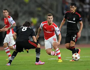 Jack Wilshere Clashes with Mustafa Pektemek and Veli Kaviak in Arsenal's UEFA Champions League Battle against Besiktas