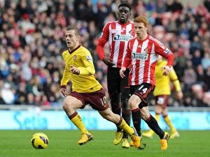 Images Dated 9th February 2013: Jack Wilshere Outmaneuvers Colback and Diaye: A Premier League Battle at Sunderland