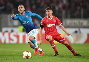 FC Koln V Arsenal 2017-18 Prints: Jack Wilshere Outmaneuvers Salih Ozcan in Arsenal's UEFA Europa League Clash vs