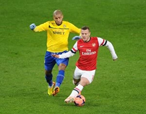 Images Dated 24th January 2014: Jack Wilshere Outruns Leon Clarke: Arsenal vs Coventry City, FA Cup Fourth Round