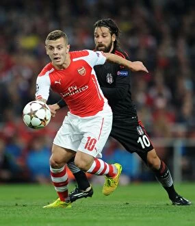 Images Dated 27th August 2014: Jack Wilshere Outruns Olcay Sahan: Arsenal FC vs Besiktas JK, UEFA Champions League Qualifiers