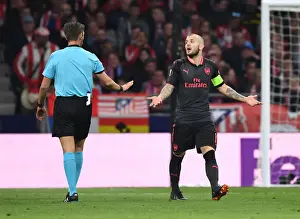 Atletico Madrid V Arsenal 2017-18 Prints: Jack Wilshere Protests to Referee Rocchi in Intense Atletico Madrid vs