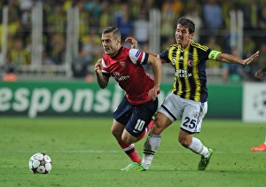 Fenerbahce V Arsenal 2013-14 Prints: Jack Wilshere vs. Emre Belozoglu: Battle in Istanbul - Arsenal's Champions League Play-offs Clash with Fenerbahce