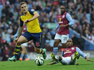 Aston Villa V Arsenal 2014-15 Prints: Jack Wilshere vs Fabian Delph: Intense Battle in Aston Villa vs Arsenal (2014-15)