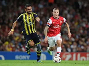 Arsenal V Fenerbahce 2013-14 Prints: Jack Wilshere vs. Gokhan Gonul: Battle in the Arsenal v Fenerbahce UEFA Champions League Clash