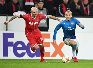 FC Koln V Arsenal 2017-18 Prints: Jack Wilshere vs. Konstanin Rausch: Battle in the Europa League between Arsenal and 1