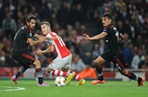 Images Dated 27th August 2014: Jack Wilshere vs. Mustafa Pektemek and Ersan Gulum: Intense Face-Off in Arsenal's UEFA Champions