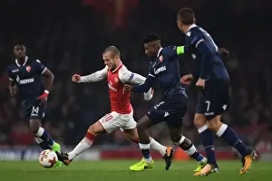 Arsenal V Red Star Belgrade 2017-18 Prints: Jack Wilshere vs. Richmond Donald: Arsenal's Clash in Europa League Action