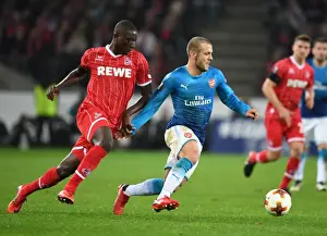 FC Koln V Arsenal 2017-18 Prints: Jack Wilshere vs. Sehrou Guirassy: Battle in the Europa League between Arsenal and 1