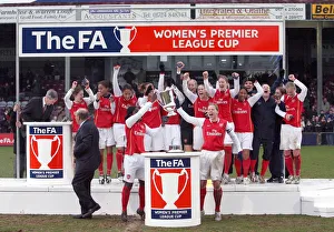 Jayne Ludlow and Anita Asante lift the League Cup Trophy for Arsenal