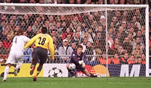 Jens Lehmann (Arsenal) punches clear under pressure from Sergio Ramos (Real)