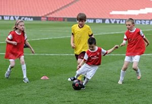 Arsenal v Aston Villa 2010-11 Collection: Jnr Gunner play on the pitch. Arsenal 1: 2 Aston Villa, Barclays Premier League