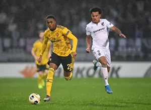 Joe Willock Clashes with Lucas Evangelista in Arsenal's Europa League Battle against Vitoria Guimaraes