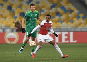 FC Vorskla Poltava V Arsenal 2018-19 Prints: Joe Willock vs. Vyacheslav Sharpar: Intense Clash in Arsenal's Europa League Battle against Vorskla Poltava