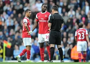 Manchester City v Arsenal 2010-11 Collection: Johan Djourou (Arsenal) is booked by Mark Clattebnburg. Manchester City 0: 3 Arsenal