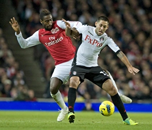 Johan Djourou of Arsenal takes on Clint Dempsey of Fulham during the Barclays Premier League match between Arsenal Johan Djourou of Arsenal takes on Clint Dempsey of Fulham during the Barclays Premier League match between Arsenal