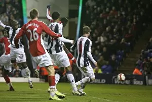 Images Dated 3rd March 2009: Kolo Toure heads past West Brom goalkeeper Scott Carson