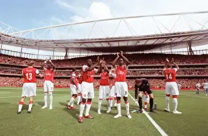 Kolo Toure and Johan Djourou (Arsenal) clap the fans along with the rest of the team