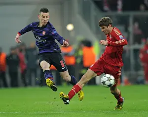 Bayern Munich V Arsenal 2012-13 Prints: Koscielny vs. Muller: Intense Battle in Bayern Munich vs