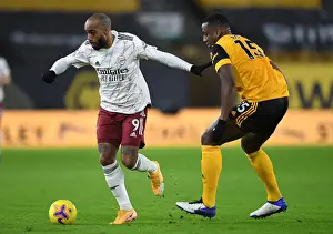 Wolverhampton Wanderers V Arsenal 2020-21 Prints: Lacazette vs. Boly: A Premier League Battle at Molineux